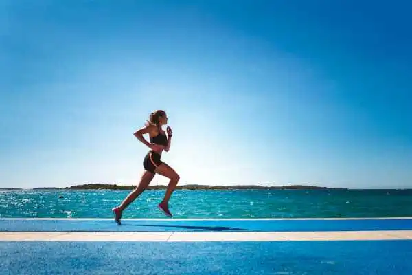 Woman running showing strong leg muscle Bordesley